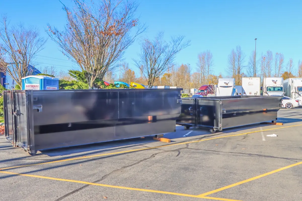 Professional dumpster rental service with roll-off container on residential driveway in Schuylkill Haven